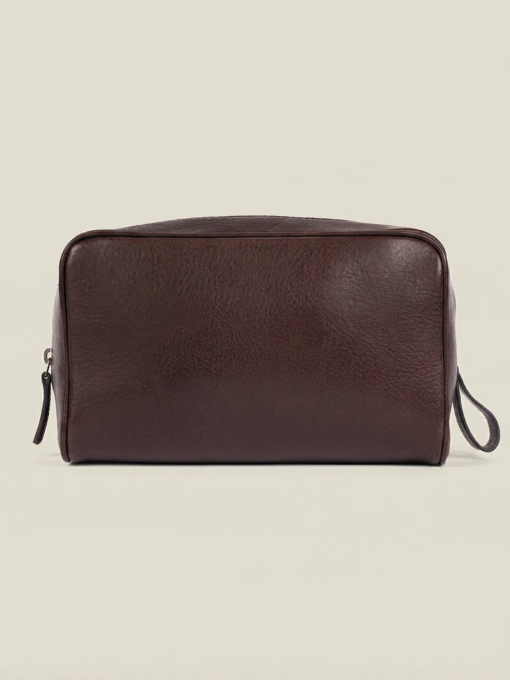 Front view of the chocolate brown leather wash bag in full-grain calfskin, featured on a neutral background.