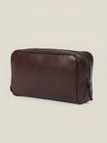 Angled view of the Chocolate Brown Leather Wash Bag in full-grain calfskin, set against a neutral background.