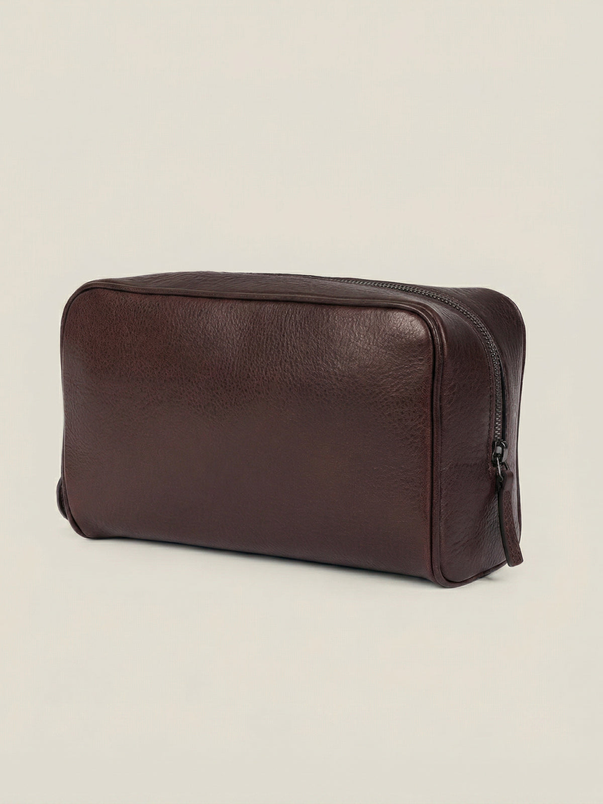 Angled view of the Chocolate Brown Leather Wash Bag in full-grain calfskin, set against a neutral background.