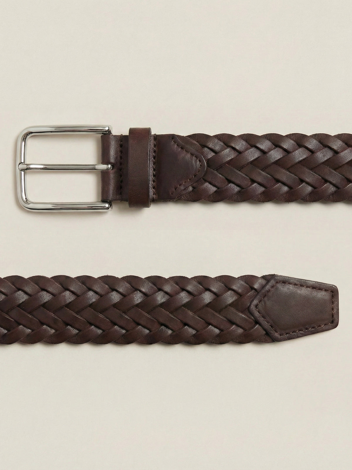 Detailed view of the woven Western Calf Leather Belt in chocolate brown with a silver-toned metal buckle.