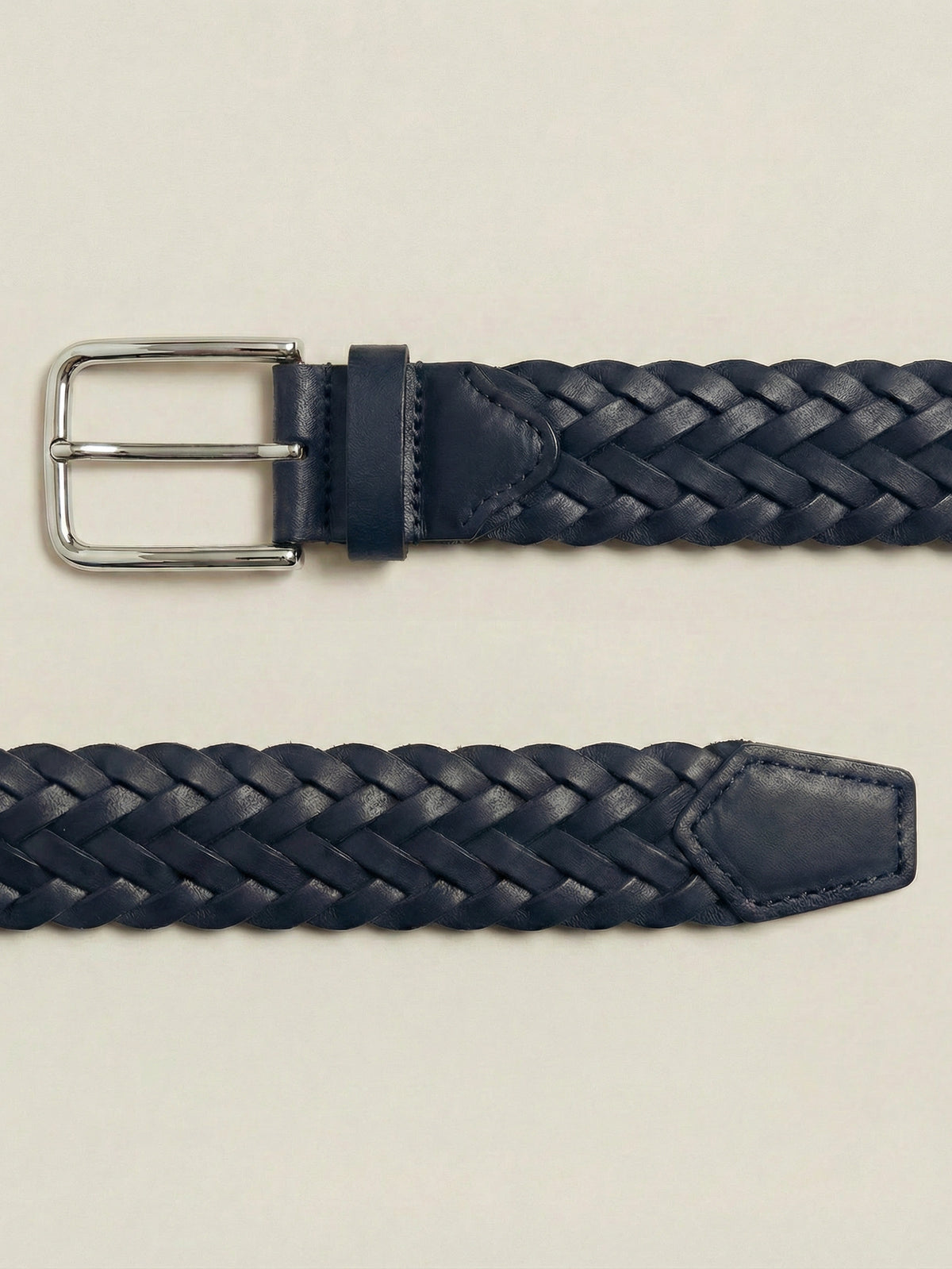 Close-up of the midnight blue woven Western Calf Leather Belt with a silver buckle, laid flat on a neutral background.