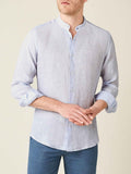 Striped sky blue linen Versilia shirt with a band collar, worn by a model against a neutral background.