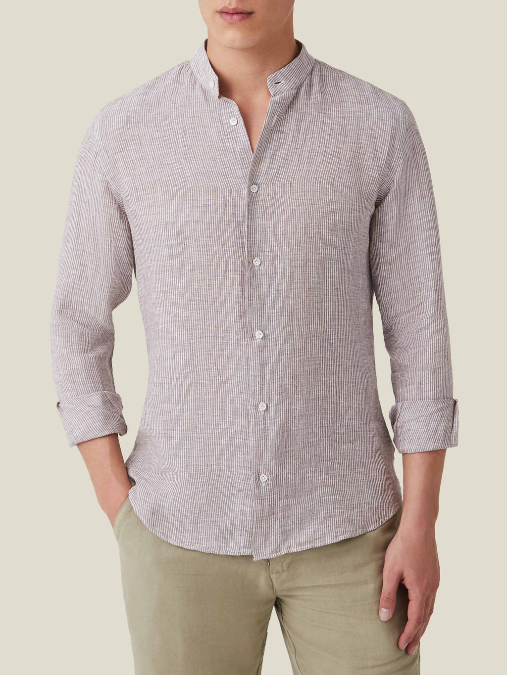 Front view of the Nocciola brown striped Versilia Linen Shirt with a band collar, worn by a model.