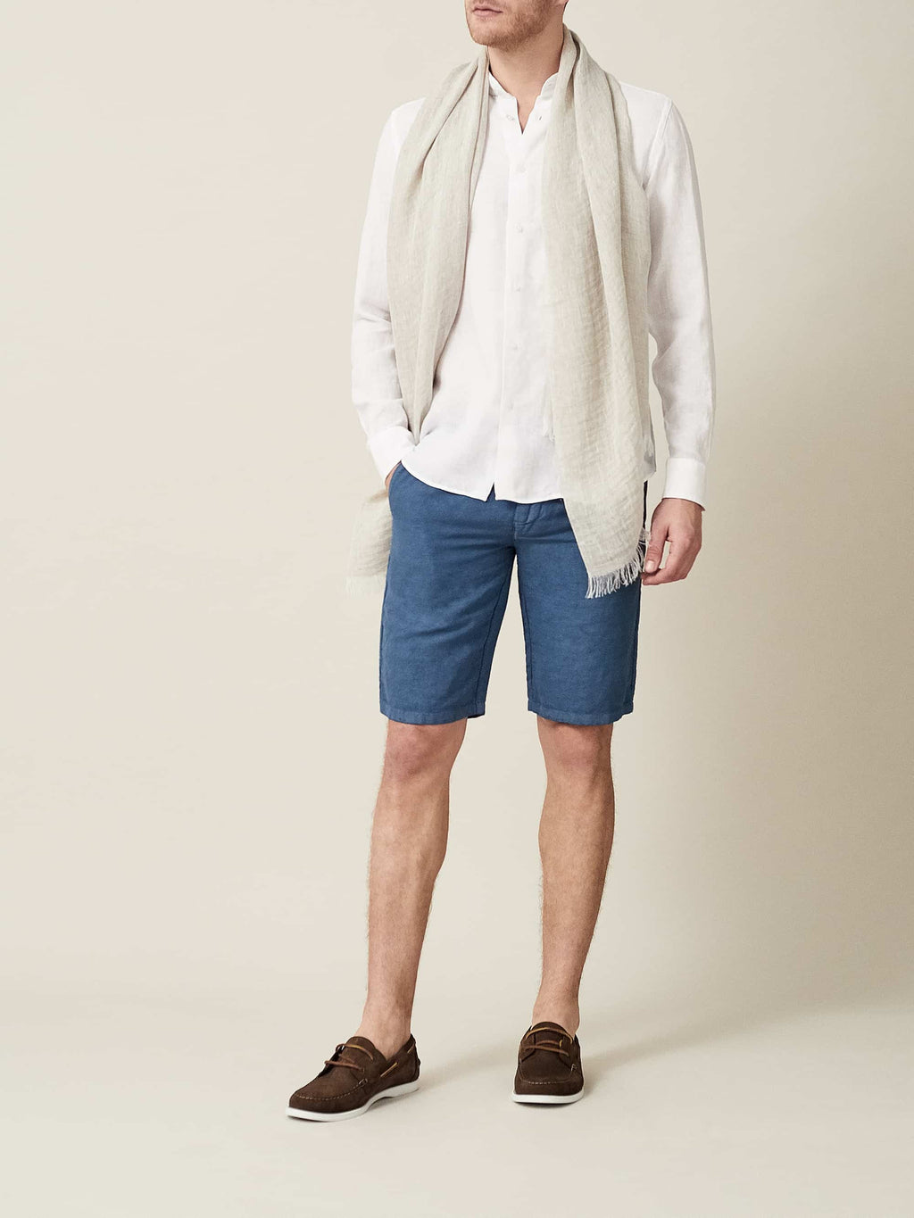 White Versilia linen shirt with a band collar, styled with a light beige scarf and blue shorts.