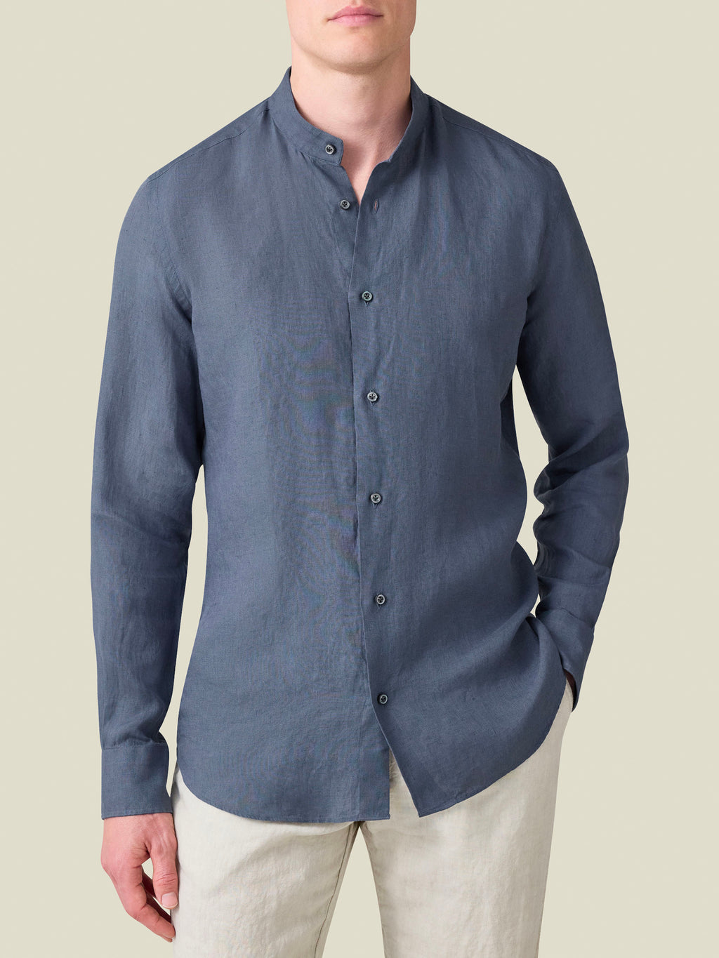Front view of the Payne's Grey Versilia Linen Shirt with a band collar, worn by a model with light trousers.