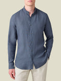 Front view of the Payne's Grey Versilia Linen Shirt with a band collar, worn by a model with light trousers.