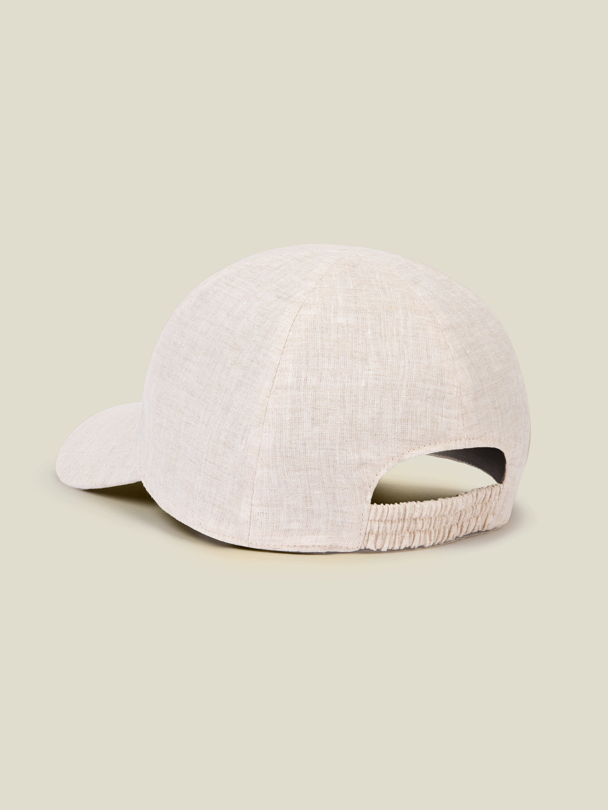Back of the Junior Linen Baseball Cap in sand, showing the detail of the elasticated strap and the pure Italian linen fabric.