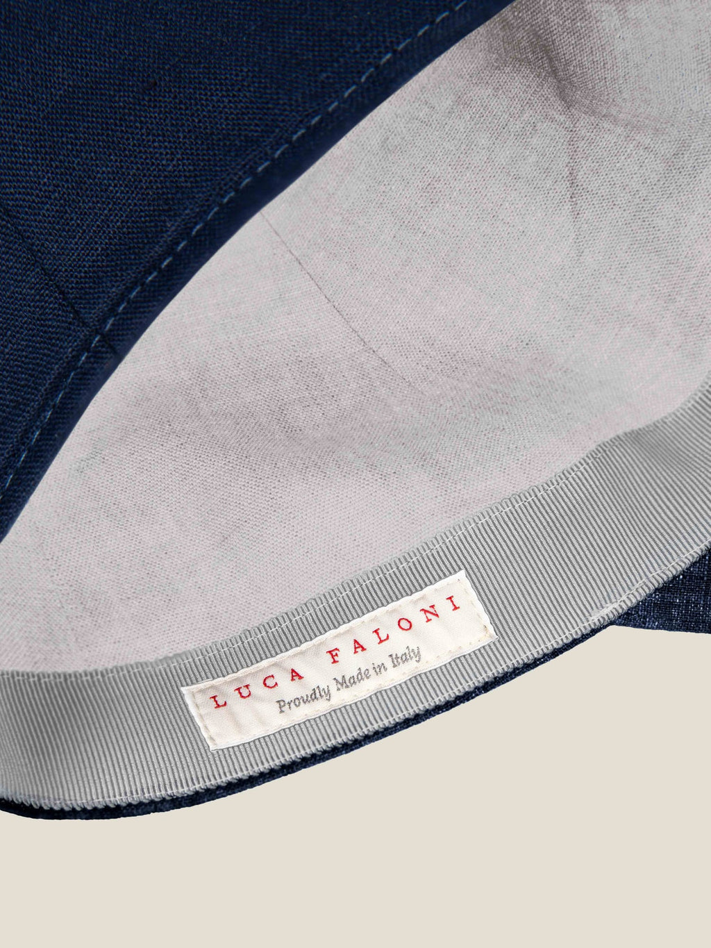 Close-up of the midnight blue Linen Baseball Cap interior, showing the contrast lining and Made in Italy label.