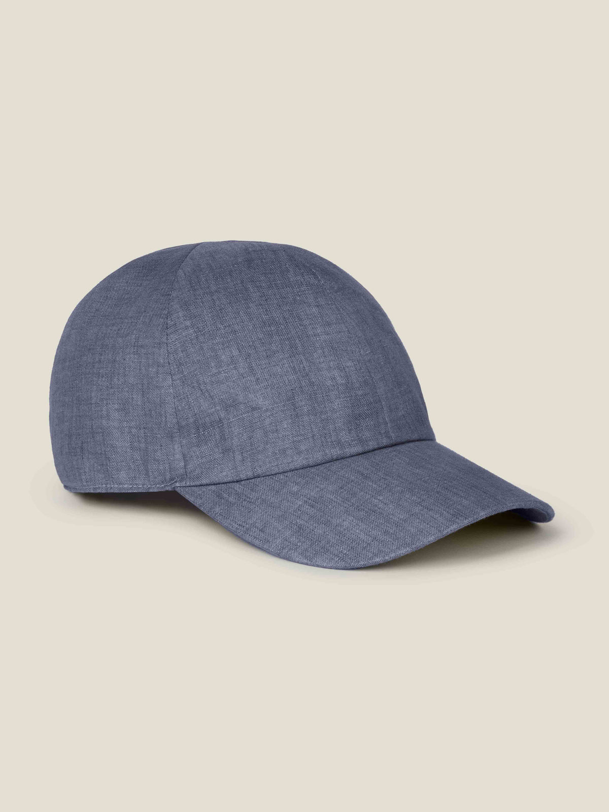 A side view of the Luca Faloni Linen Baseball Cap in Payne's Grey, showcasing its texture and classic six-panel design.