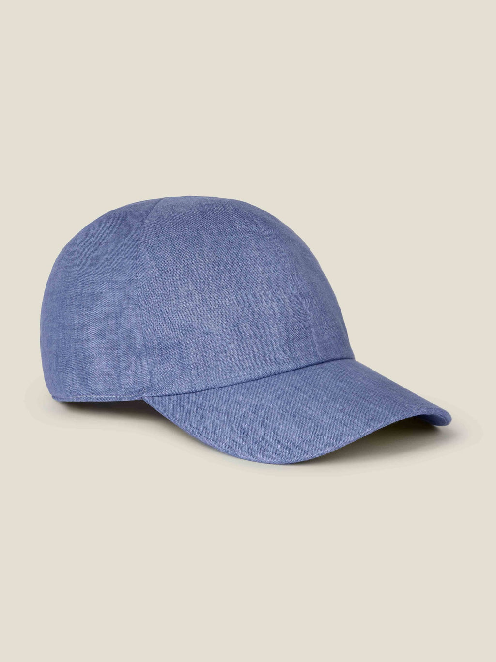 Side profile view of the Luca Faloni Linen Baseball Cap in chambray blue against a plain background.