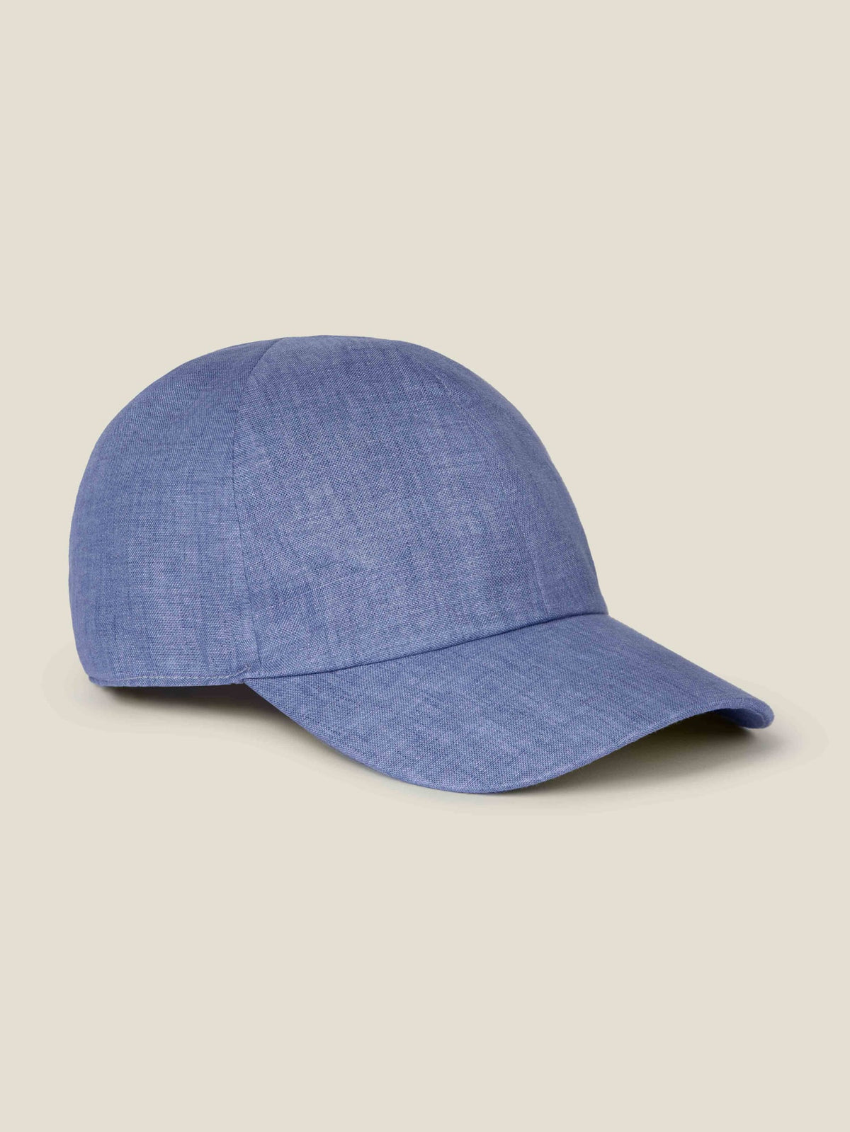 Side profile view of the Luca Faloni Linen Baseball Cap in chambray blue against a plain background.