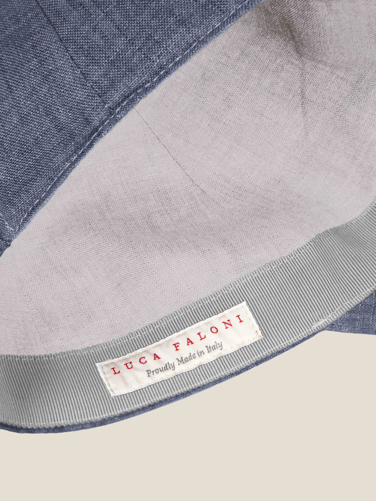 Interior detail of the Payne's Grey Linen Baseball Cap, showcasing the Luca Faloni 'Proudly Made in Italy' label.