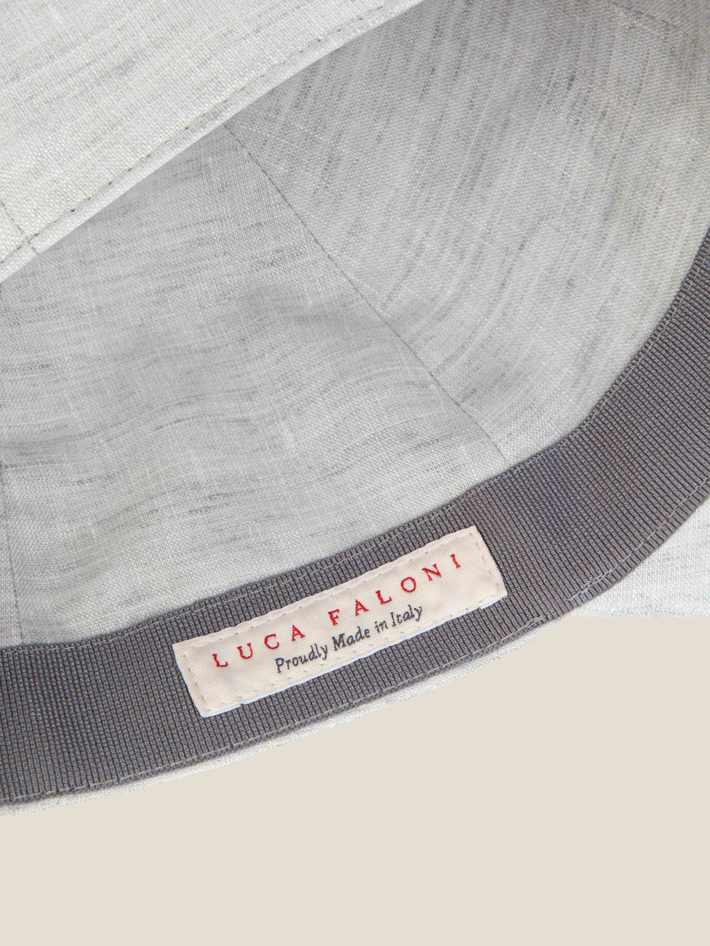 Close-up of the 'Made in Italy' label and inner band of the Luca Faloni Light Grey Linen Baseball Cap.