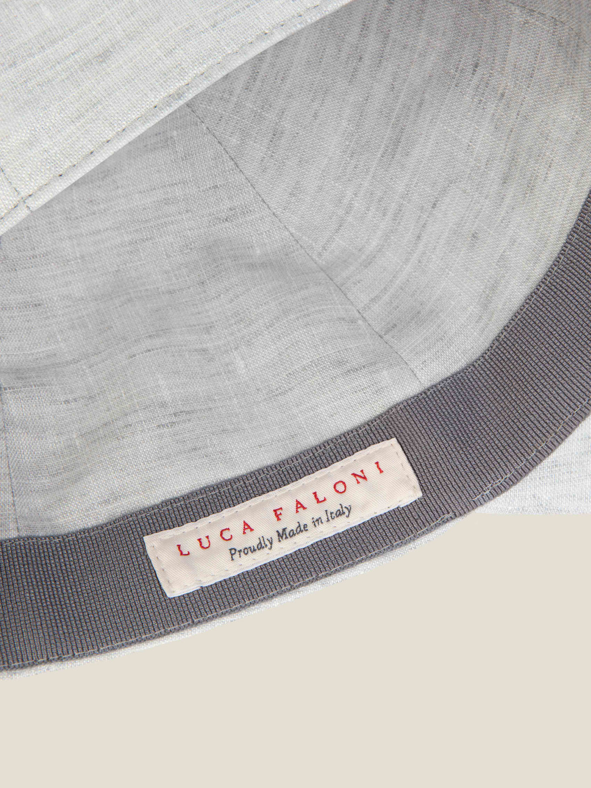Close-up of the 'Made in Italy' label and inner band of the Luca Faloni Light Grey Linen Baseball Cap.