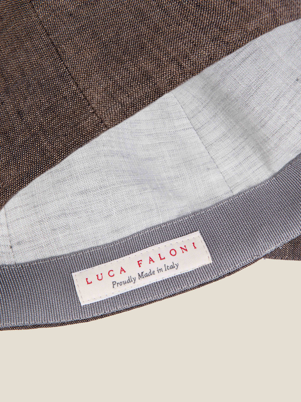 Interior detail of the Luca Faloni Chocolate Brown Linen Baseball Cap, highlighting the 'Proudly Made in Italy' label.