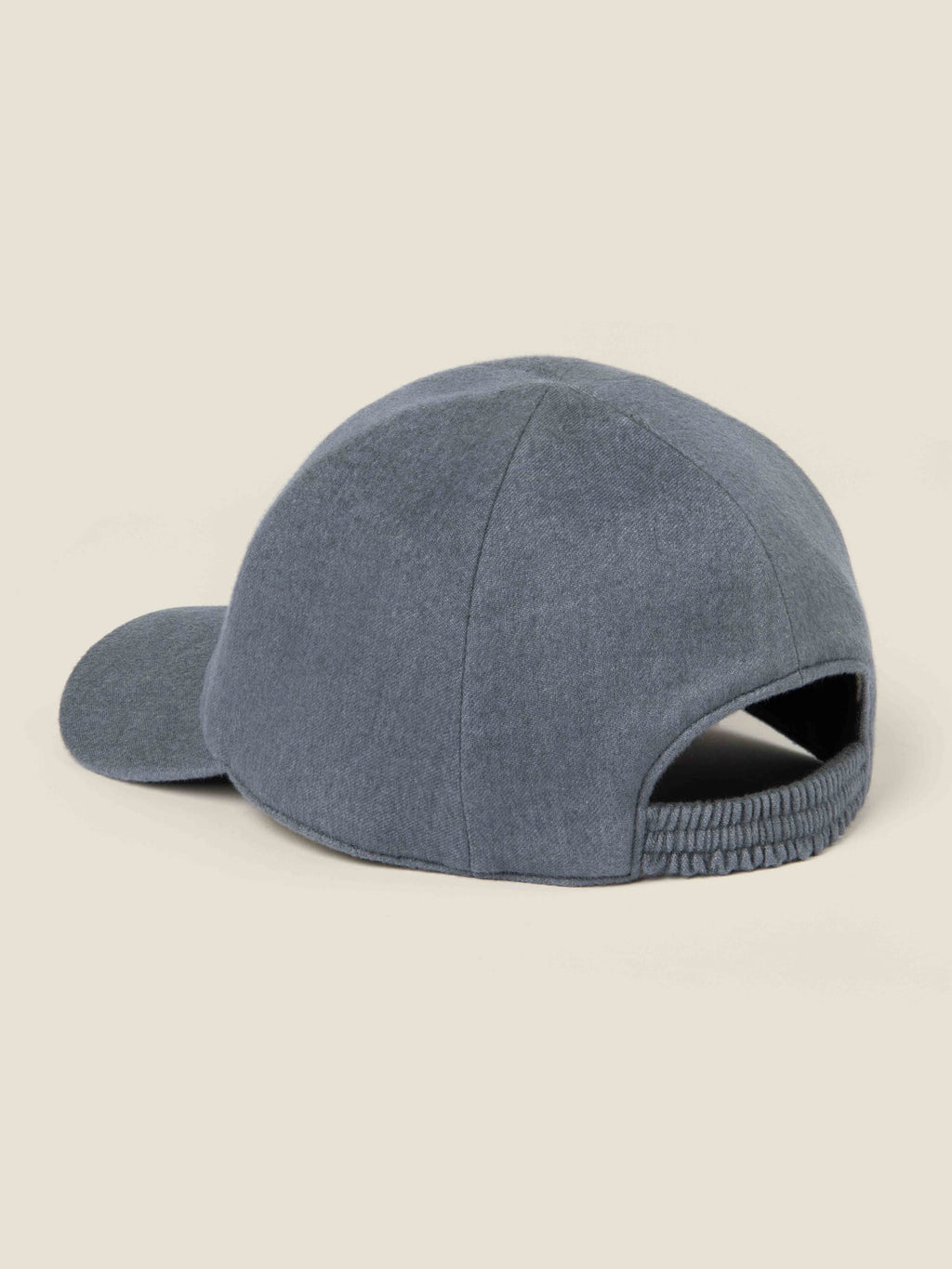 Back three-quarter view of the Whale Blue Cashmere Baseball Cap, highlighting the elasticated back strap.