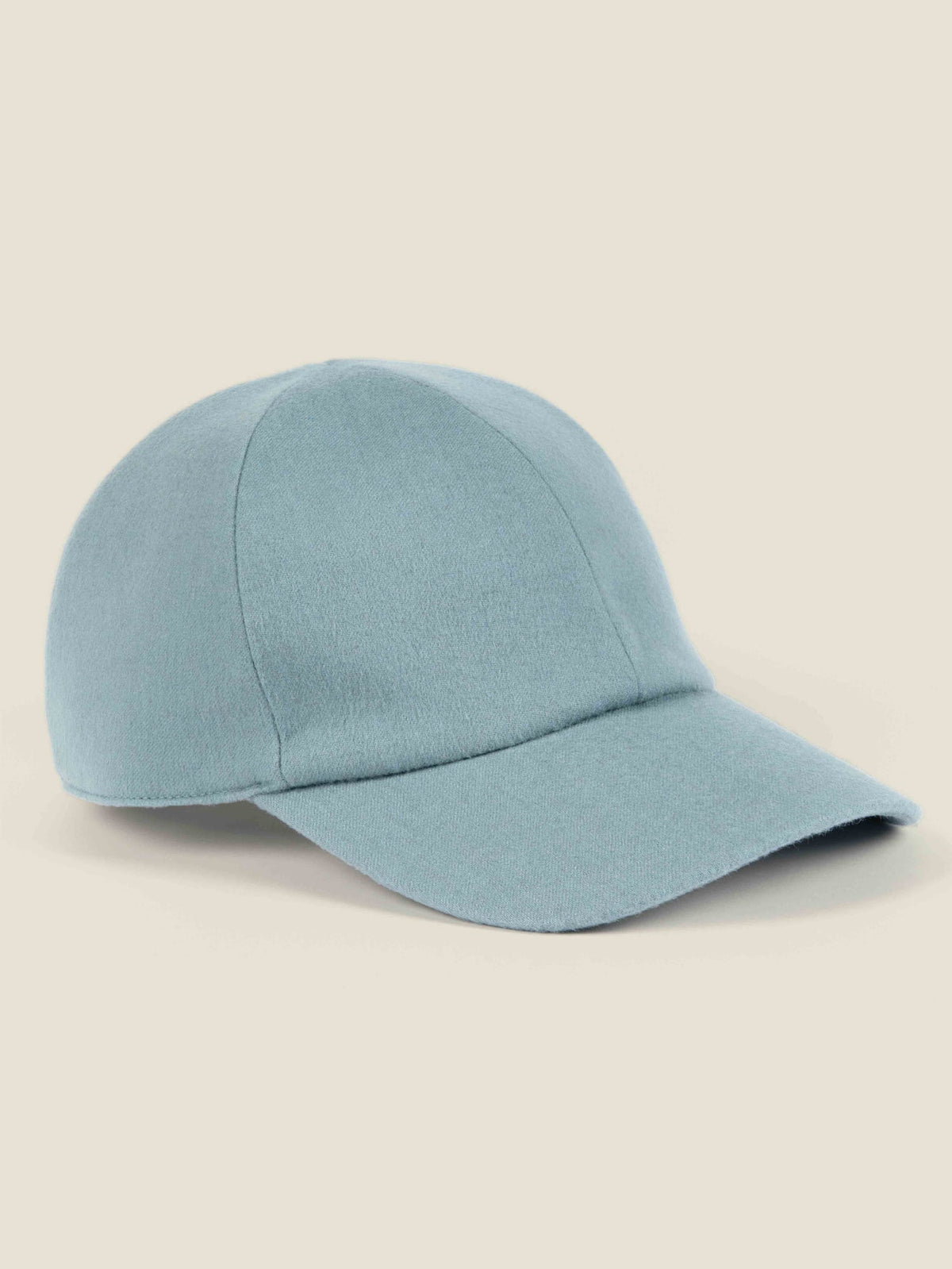 A side view of the Luca Faloni Cashmere Baseball Cap in French Blue, showcasing the soft brushed texture of the fabric.