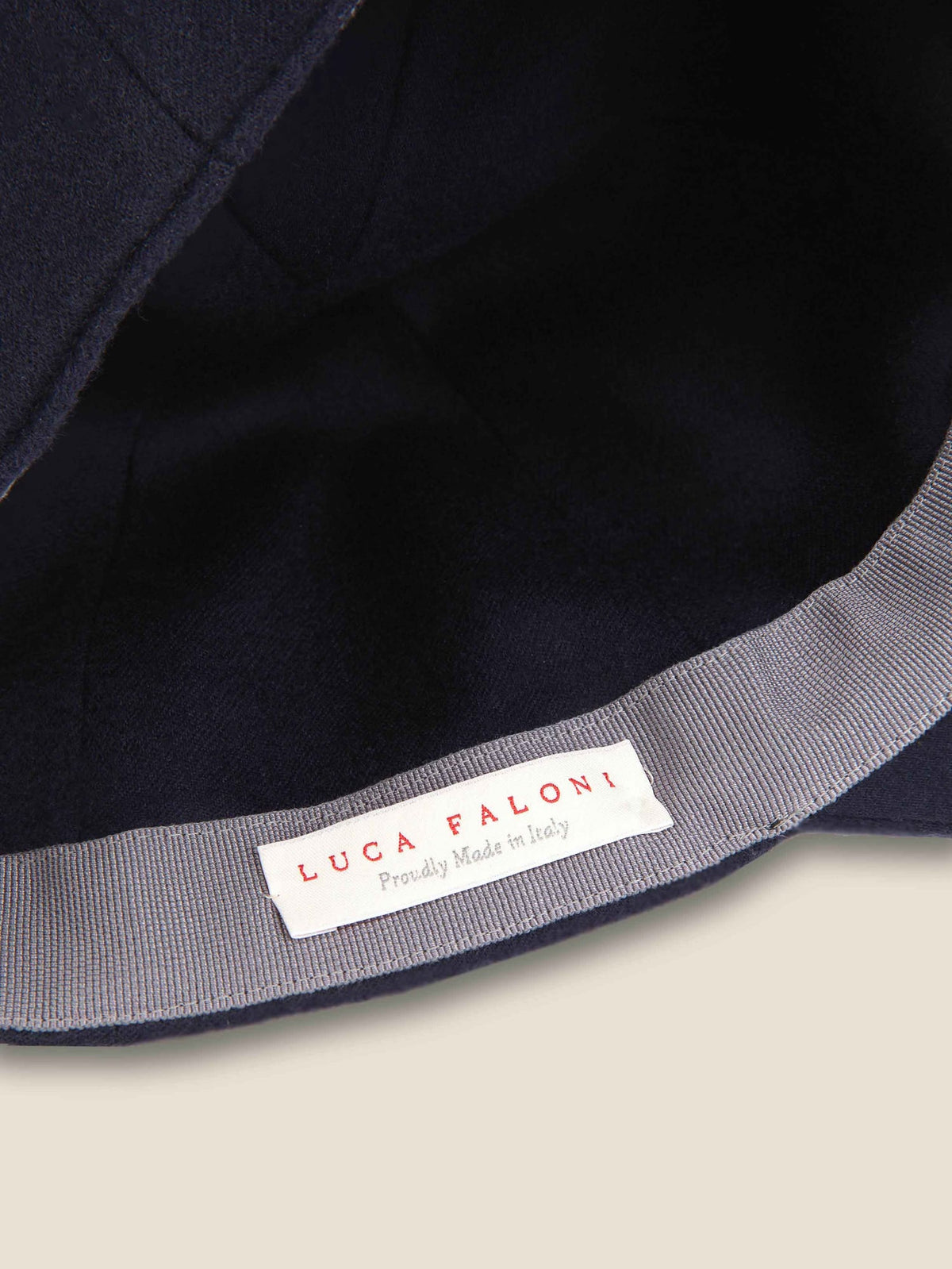 Interior detail of the Navy Blue Cashmere Baseball Cap, highlighting the Luca Faloni 'Proudly Made in Italy' label.