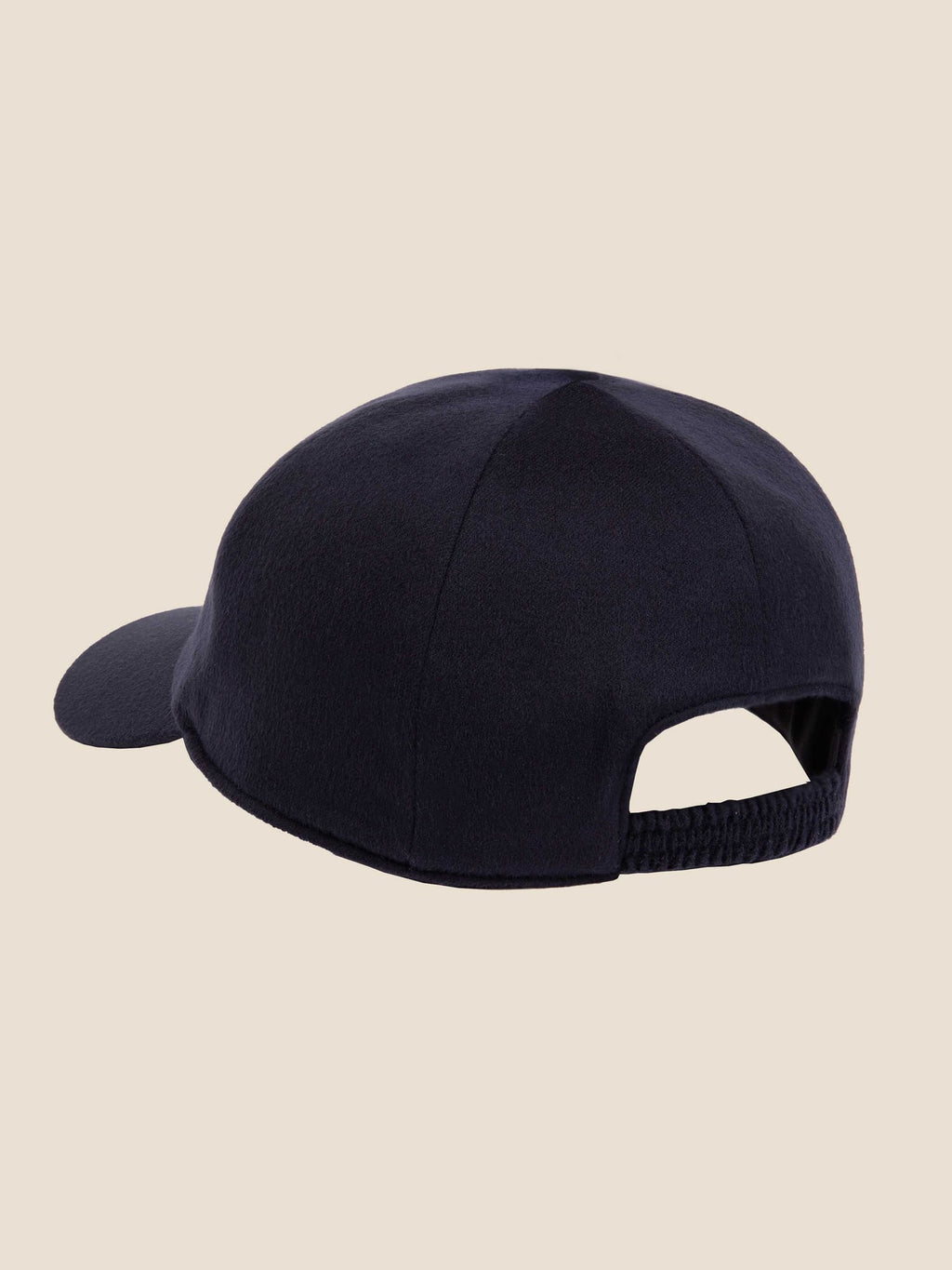 Back view of the navy blue cashmere baseball cap, highlighting its elasticated strap.