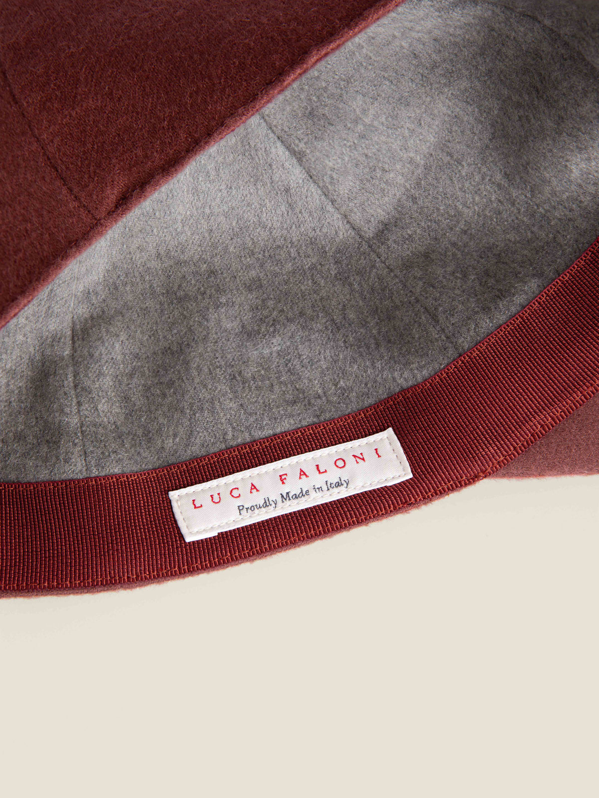 Detail of the 'Made in Italy' label and soft inner lining of the Luca Faloni rust cashmere baseball cap.