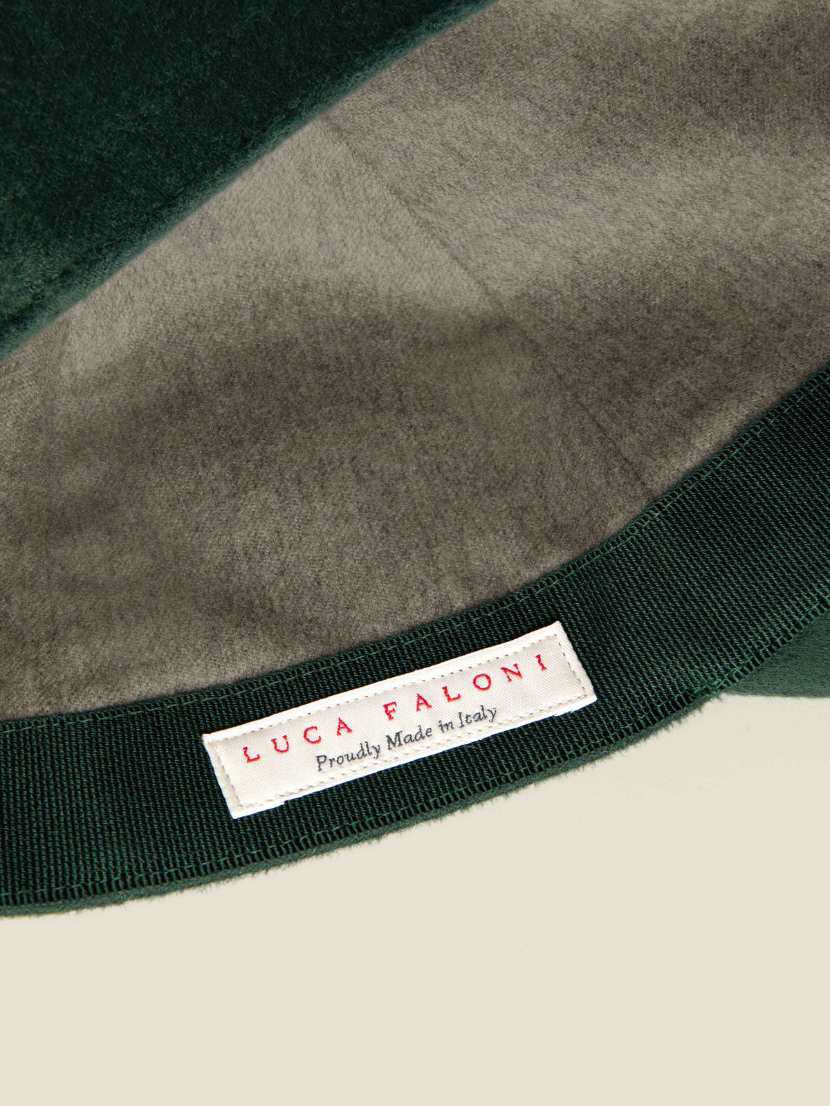 Close-up of the 'Proudly Made in Italy' label inside the Luca Faloni Forest Green Cashmere Baseball Cap.