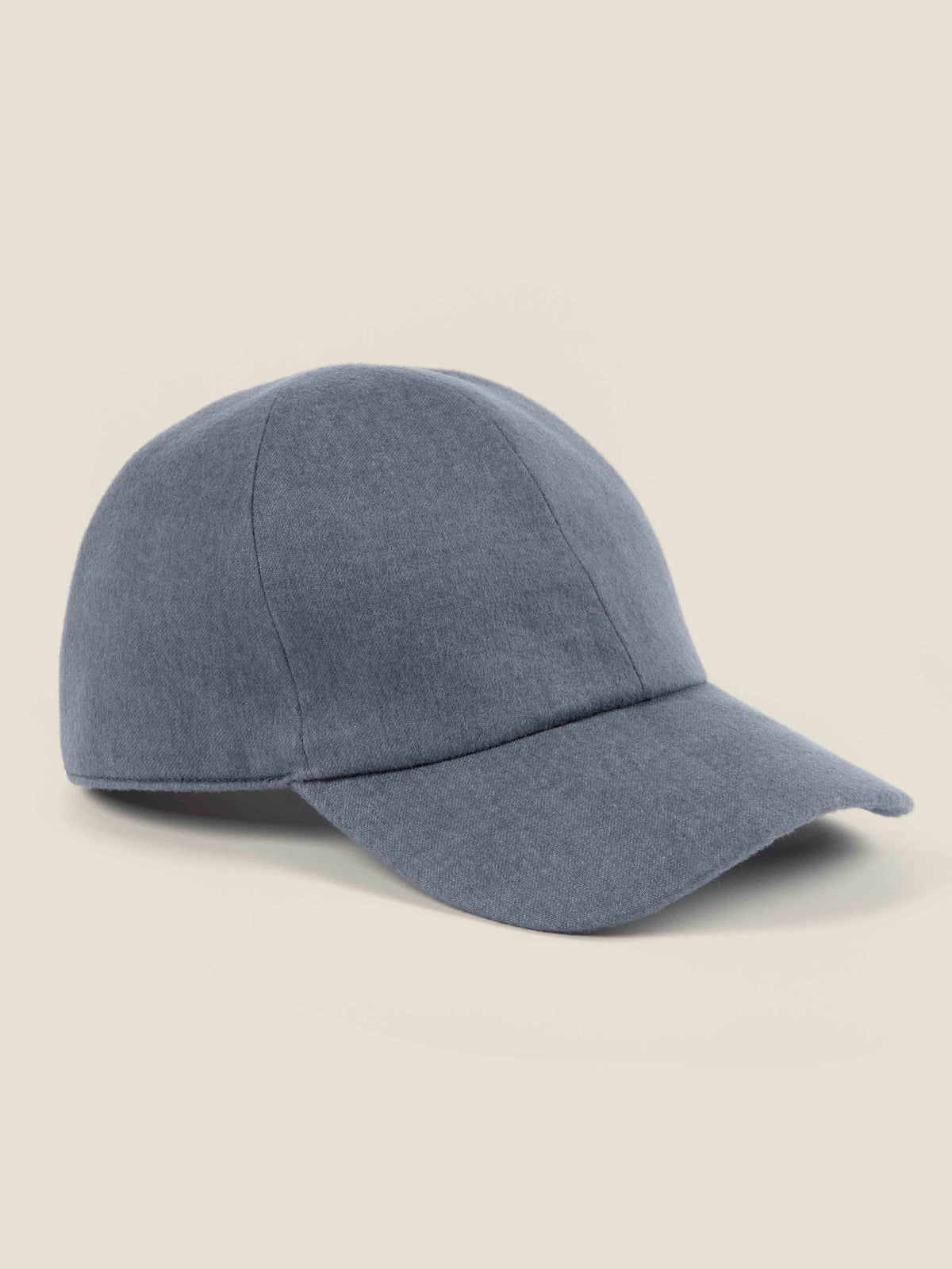 A side view of the Luca Faloni cashmere baseball cap in whale blue on a plain background.