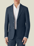 Front view of a model wearing the slim-fit Luca Faloni Linen Blazer in Navy Blue with a white shirt and matching trousers.