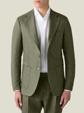 Front view of a model wearing the Luca Faloni Linen Blazer in Olive Green, paired with a white shirt and matching trousers.