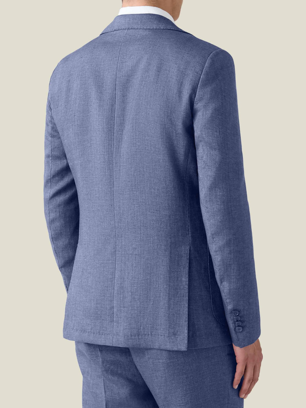 Back view of a man wearing the Azure Linen Blazer, showing the slim fit, double vents and natural linen texture.