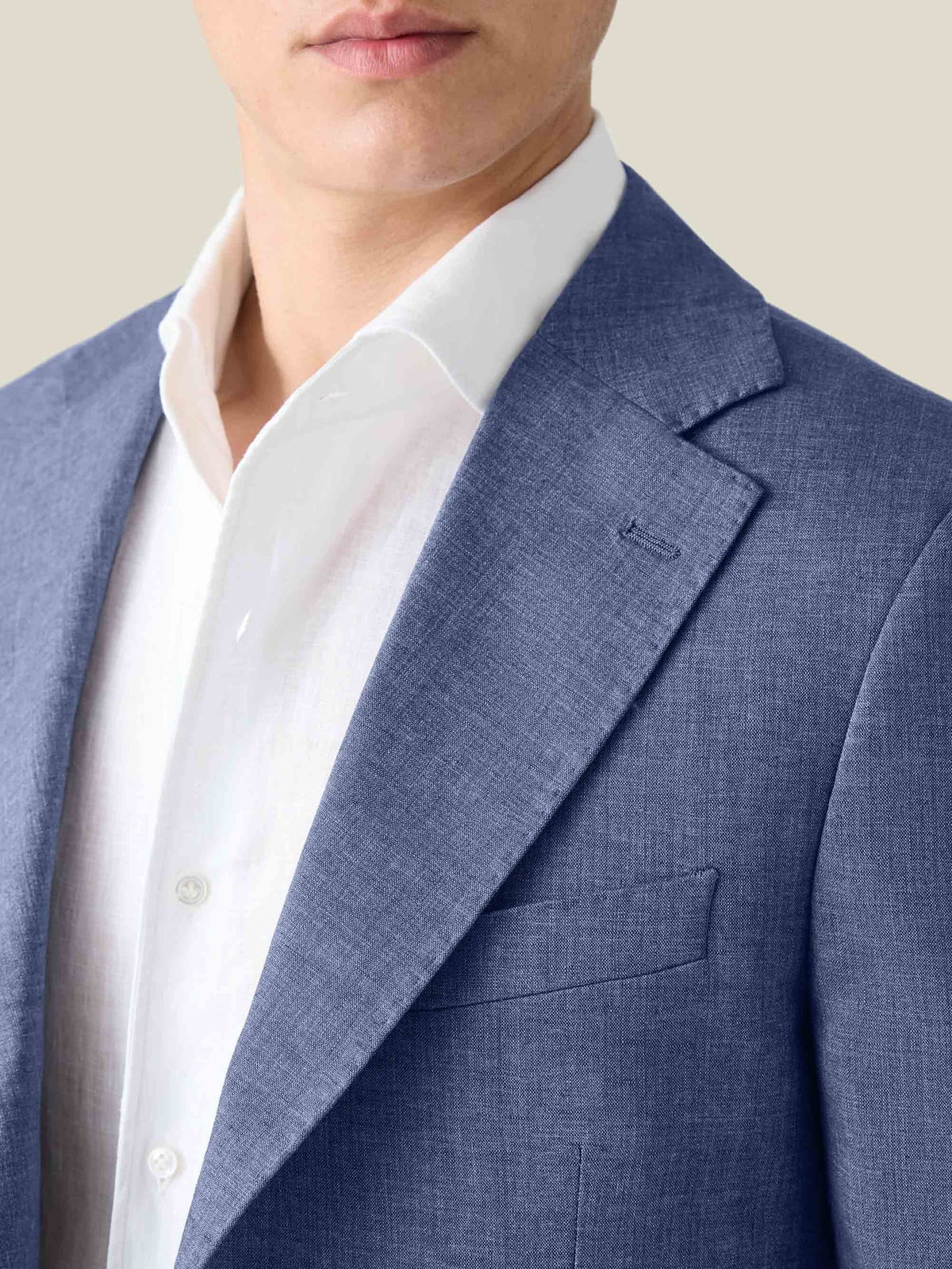 A close-up of the Luca Faloni Azure Linen Blazer, showing the textured fabric, notch lapel, and fit over a white shirt.