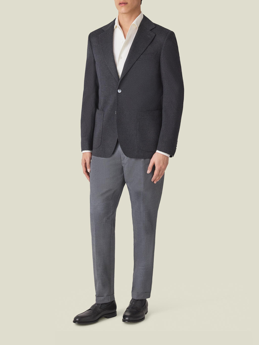 Full-length shot of a man wearing the Luca Faloni Charcoal Grey Cashmere Blazer over a white shirt and grey trousers.