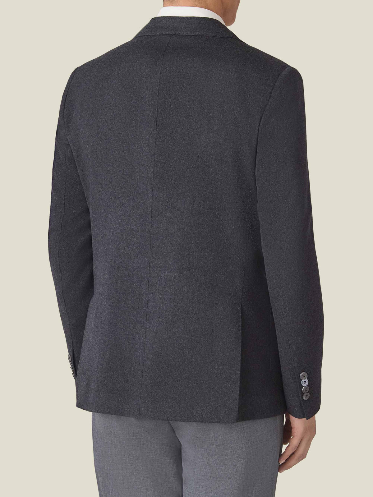 Back view of a model wearing the Luca Faloni Cashmere Blazer in Charcoal Grey, showcasing its slim fit.