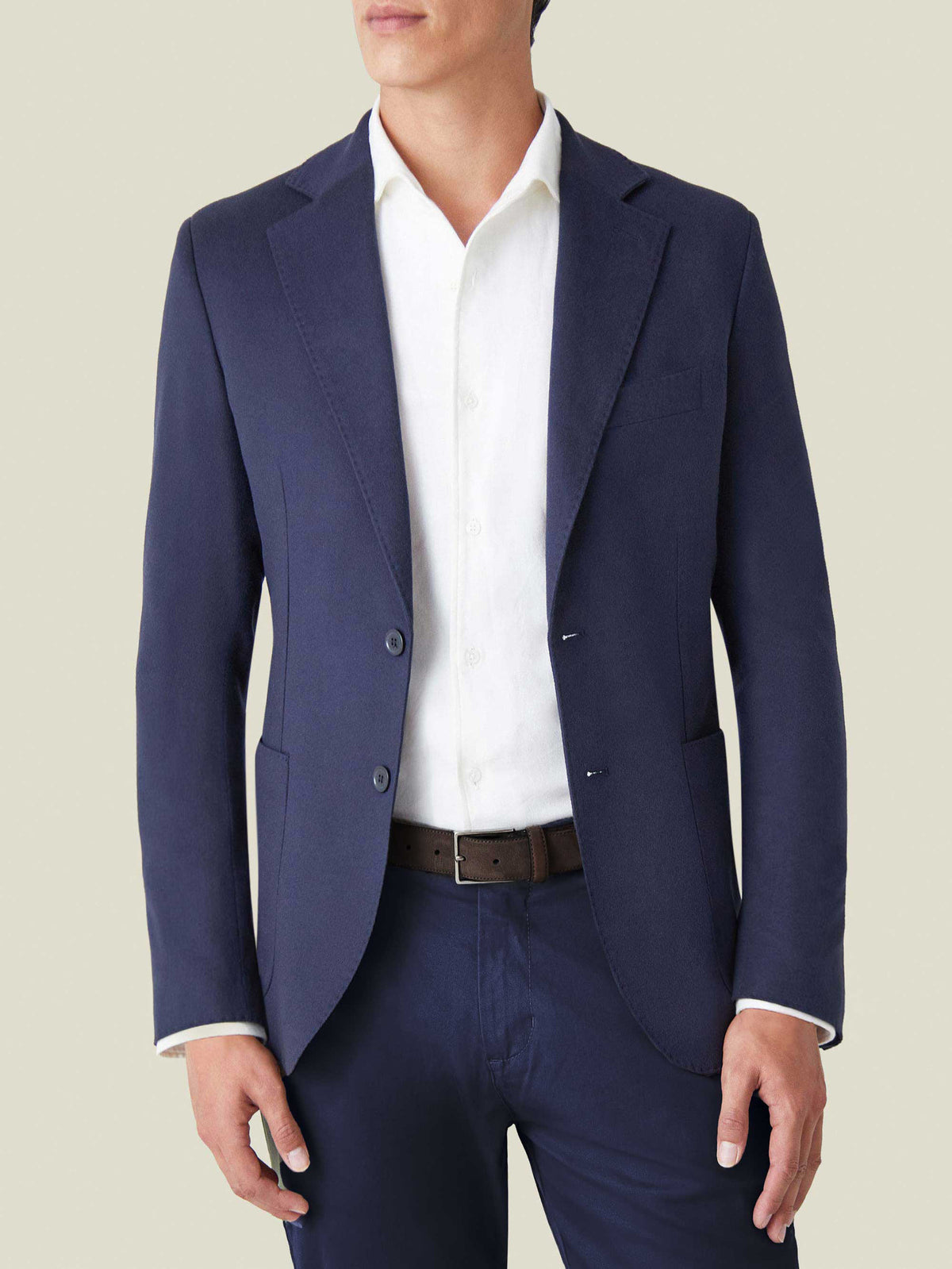 A front view of a model wearing the Luca Faloni Navy Blue Cashmere Blazer, styled with a white shirt and matching trousers.