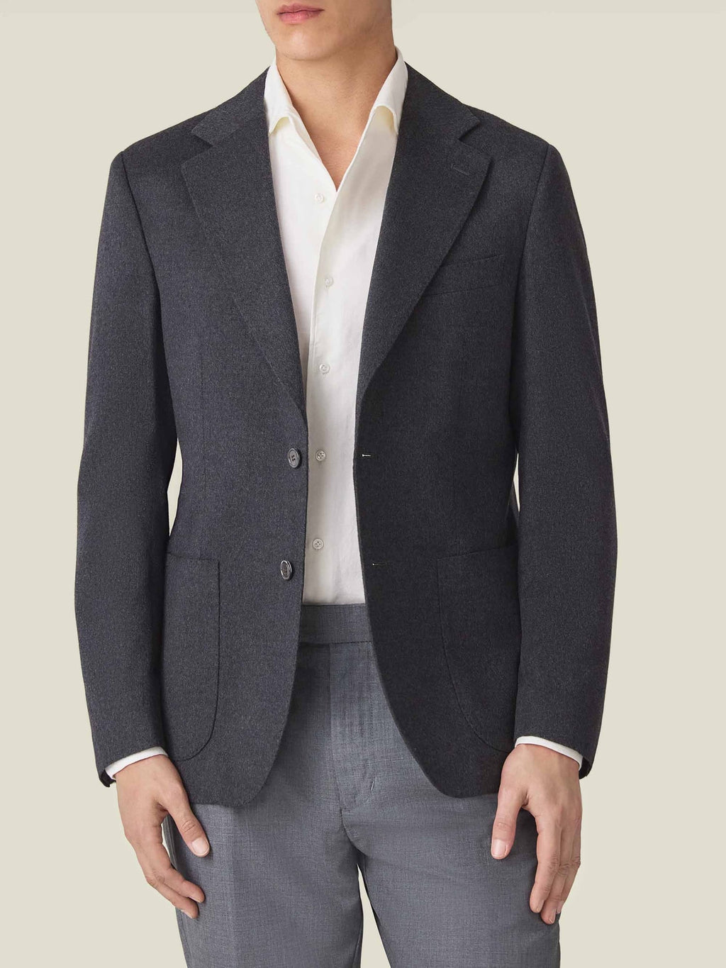 A front view of a model wearing the Luca Faloni Charcoal Grey Cashmere Blazer with a white shirt and grey trousers.