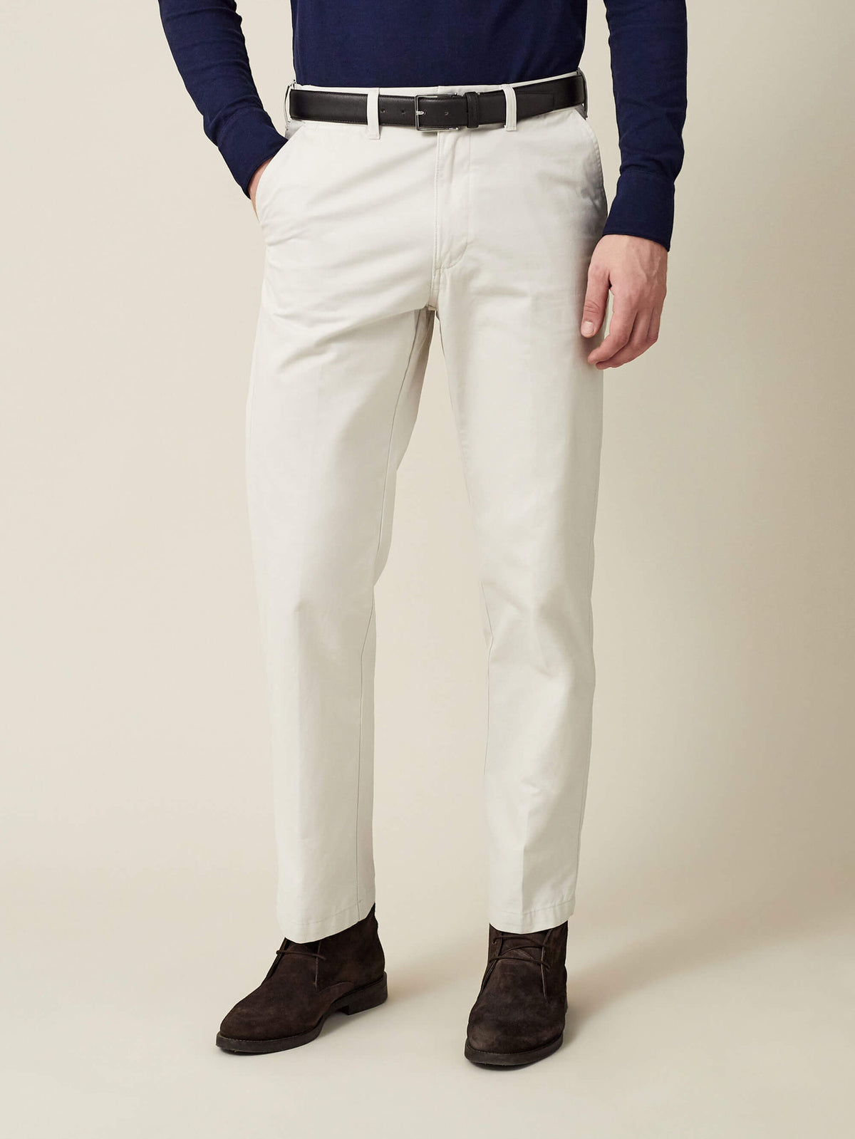 A model wears the Luca Faloni Black Calf Leather Belt with off-white chinos, a navy top, and dark brown suede shoes.