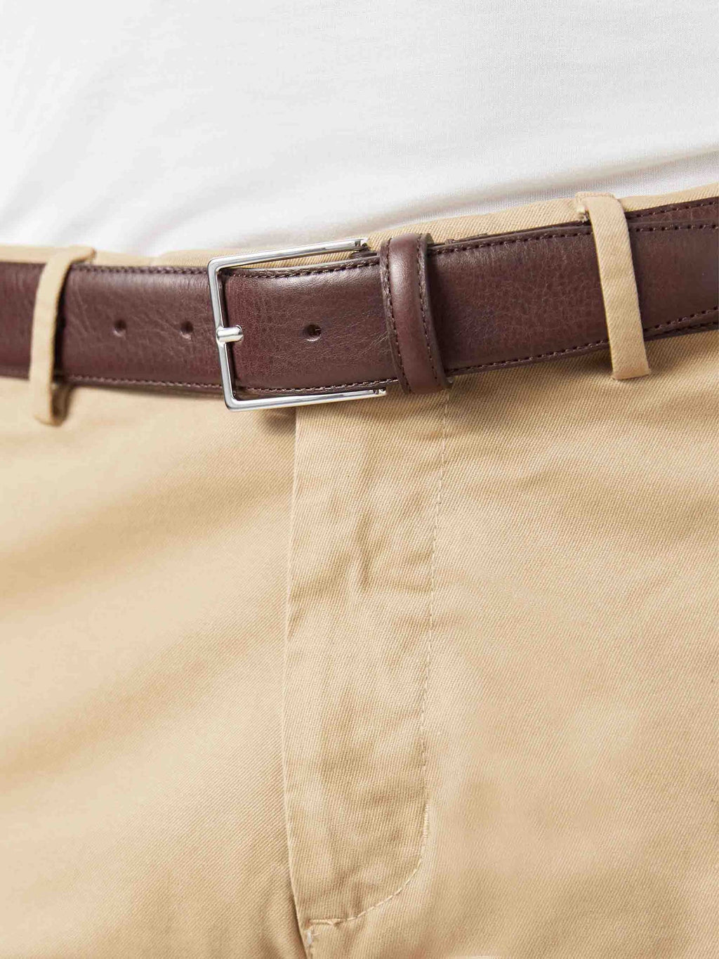 A close-up of the Luca Faloni Dark Brown Calf Leather Belt worn with beige chinos, highlighting the nickel buckle.