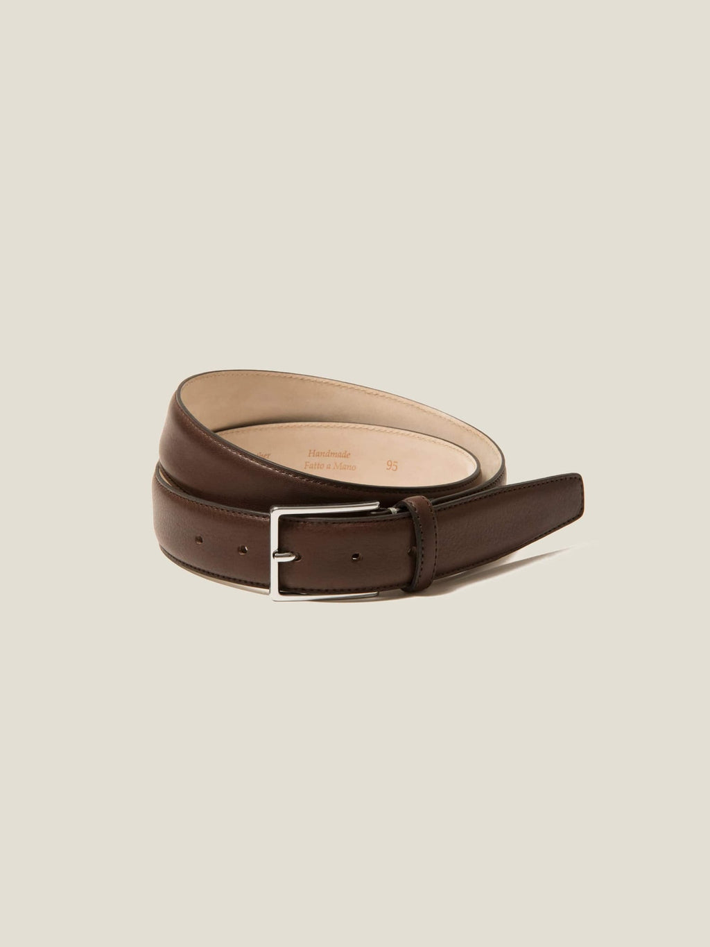 A coiled dark brown calf leather belt with a silver buckle, handcrafted in Italy.