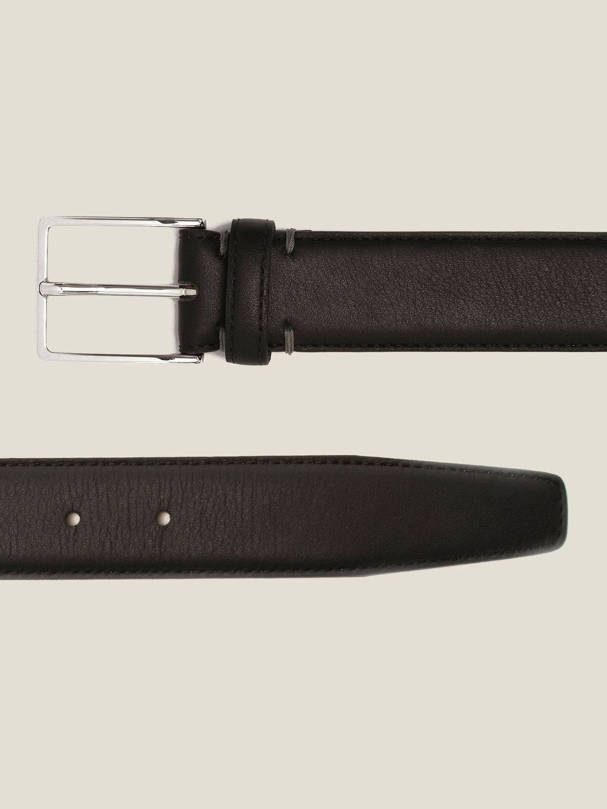 A close-up shot of the Luca Faloni Black Calf Leather Belt, highlighting its silver buckle and smooth leather finish.