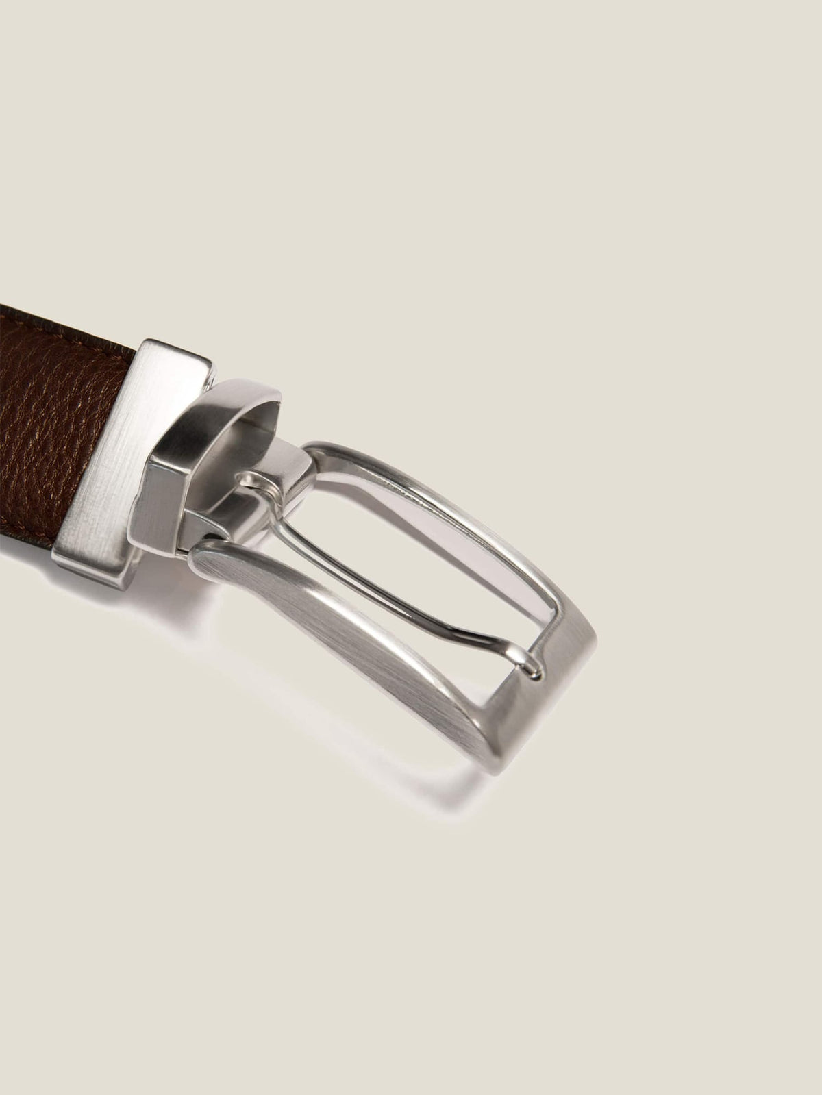 Close-up of the rotating nickel-finish buckle on the brown side of the Reversible Calf Leather Belt.
