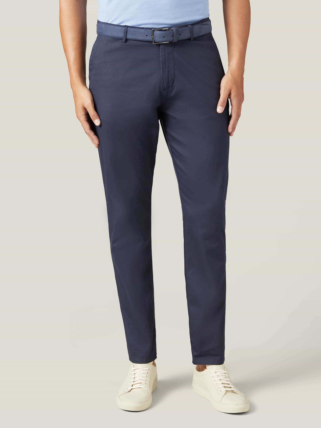 Model wearing the navy blue Nubuck Belt with navy chinos and a light blue polo shirt.