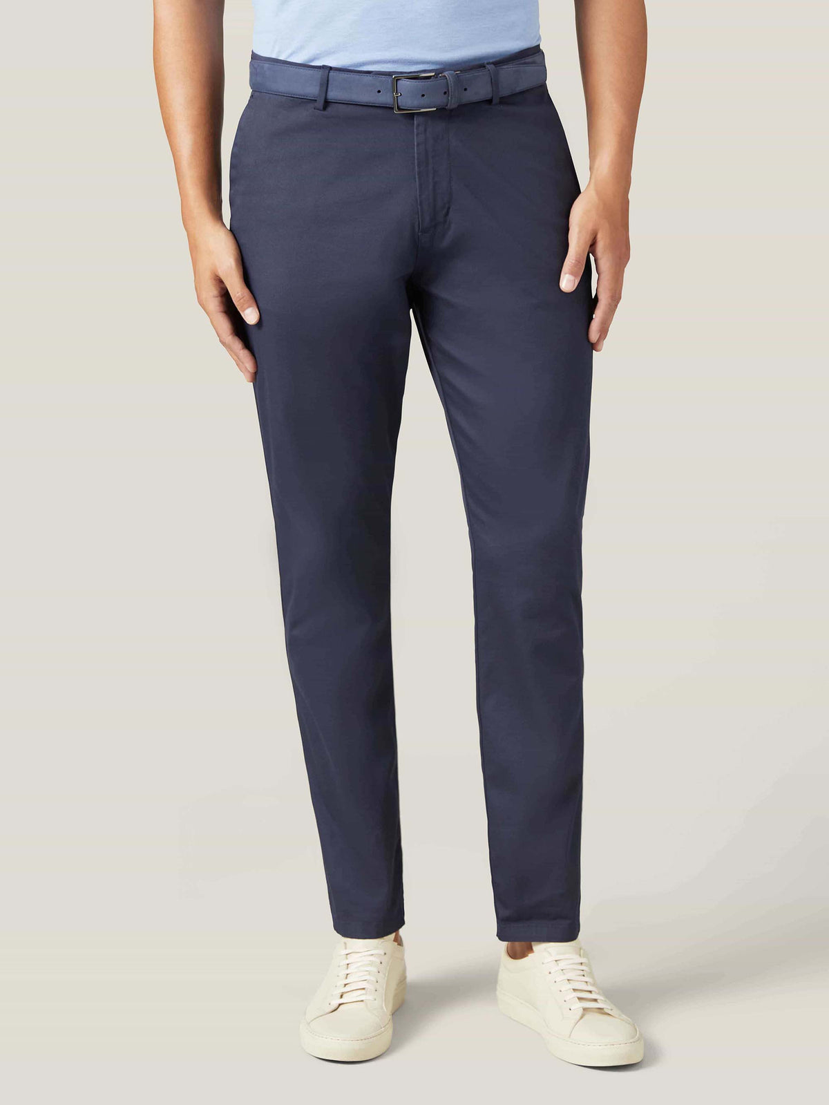 Model wearing the navy blue Nubuck Belt with navy chinos and a light blue polo shirt.