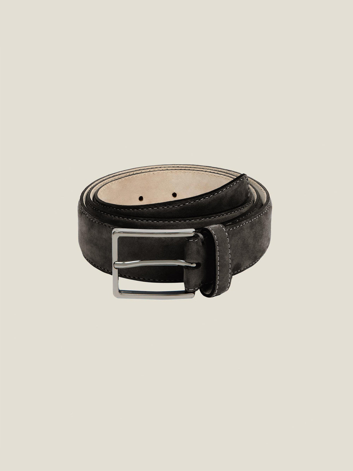 Product shot of the Luca Faloni Black Nubuck Belt, coiled to showcase its velvety texture and silver buckle.