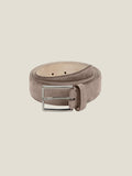 Luca Faloni's Nubuck Leather Belt in Hazelnut Brown, coiled up to showcase its soft, velvety texture and silver buckle.