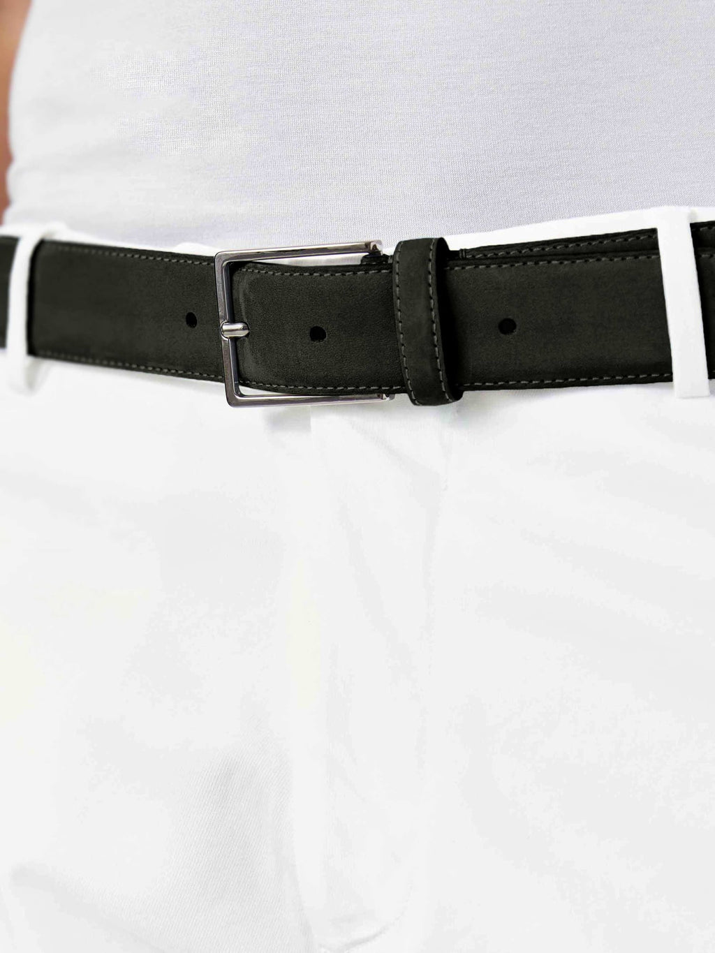 Close-up of the Luca Faloni black nubuck belt with a silver buckle, worn with white trousers and a white t-shirt.