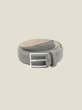 A coiled Classic Suede Belt in French Blue, showing its full length and silver buckle against a studio background.