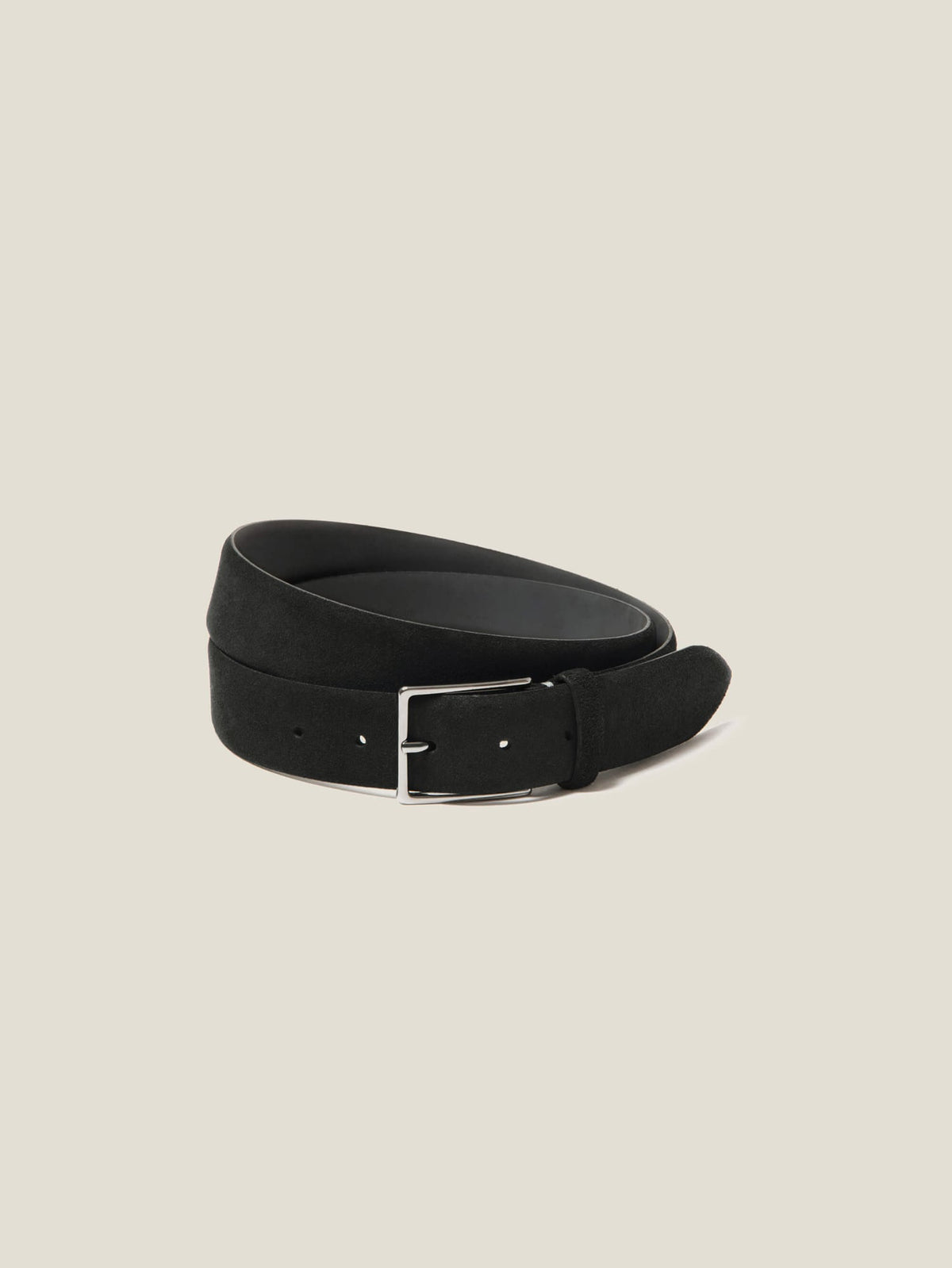 A coiled view of the Luca Faloni Classic Suede Belt in Black, highlighting its soft suede and silver buckle.