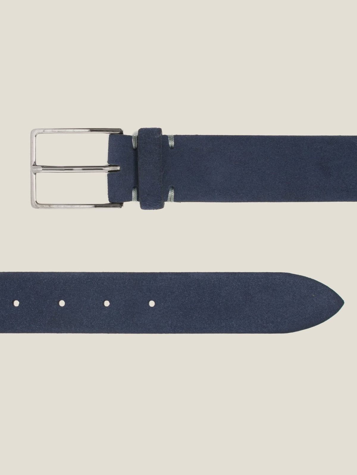 A detailed view of the Classic Suede Belt in navy blue, highlighting its silver buckle and fine suede texture.