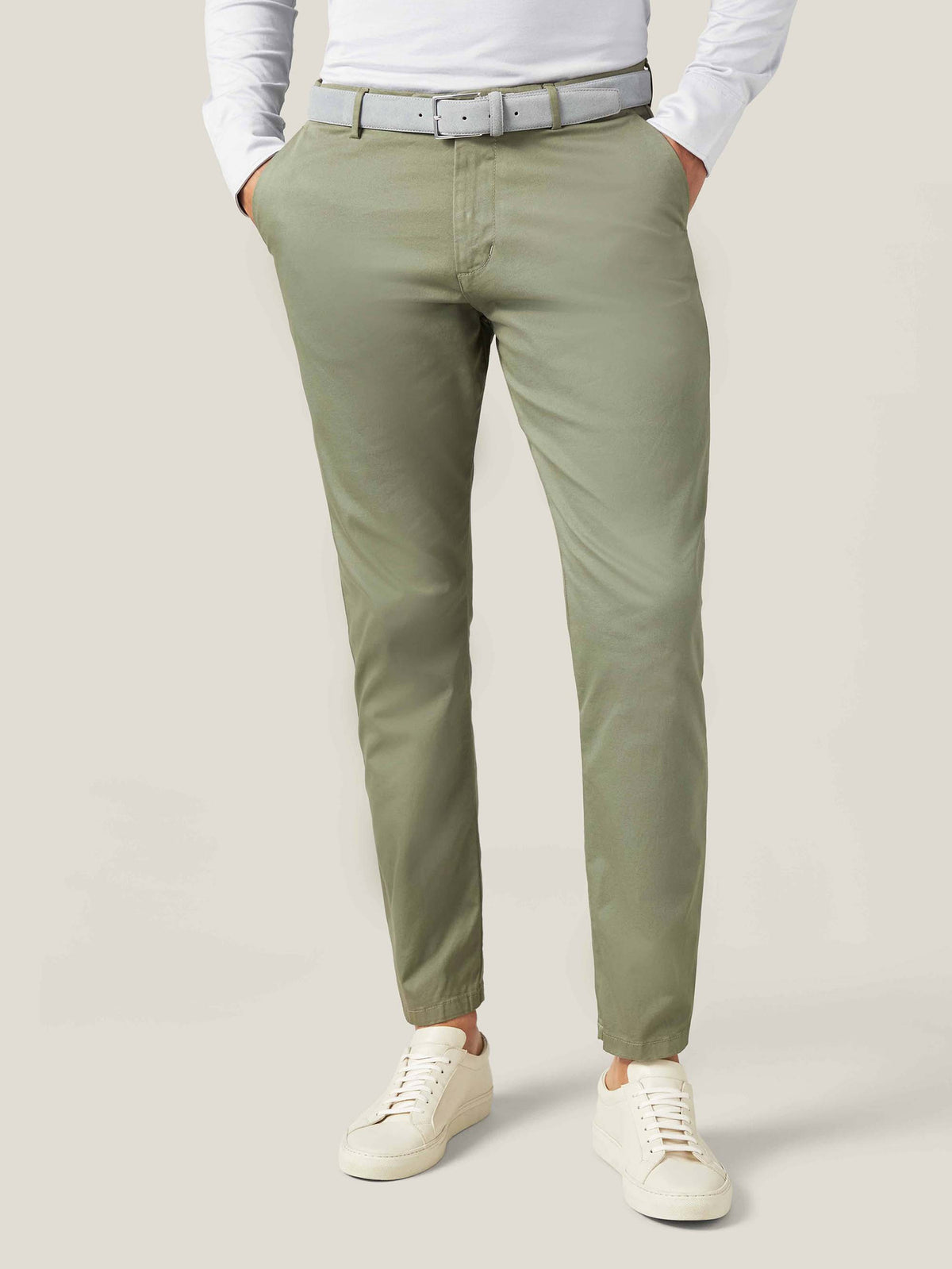 Model wearing the French Blue Classic Suede Belt from Luca Faloni, styled with olive green chinos and a white shirt.