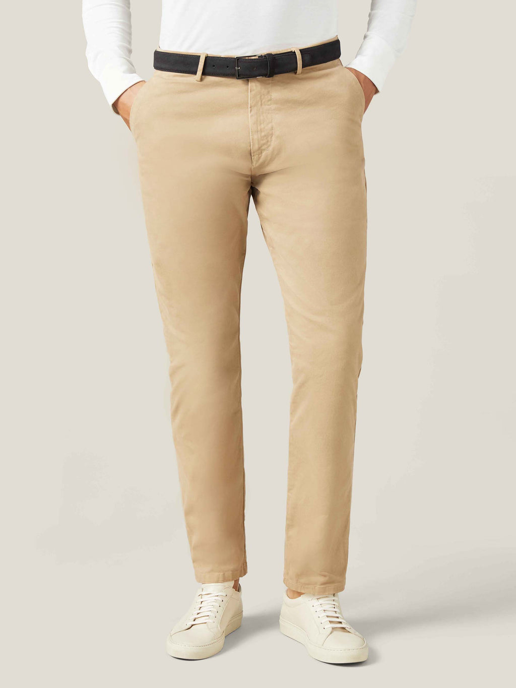 Model seen from the front wearing Luca Faloni's black Classic Suede Belt with beige chinos and a white long-sleeve top.