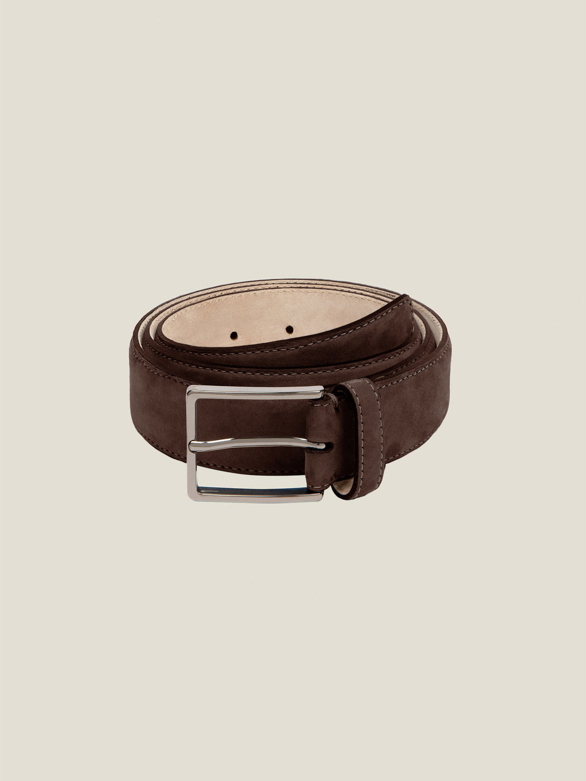 A coiled view of the Luca Faloni Classic Suede Belt in Dark Brown, showcasing its soft texture and silver buckle.
